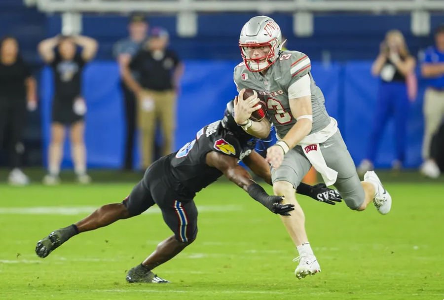 Sep 13, 2024; Kansas City, Kansas, USA; UNLV Rebels quarterback Matthew Sluka (3) runs the ball against Kansas Jayhawks safety O.J. Burroughs (5) during the second half at Children's Mercy Park. Mandatory Credit: Jay Biggerstaff-Imagn Images