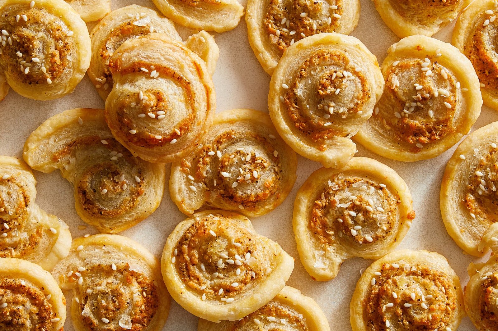 An overhead image of pastry pinwheels finished with sesame seeds and za’atar.