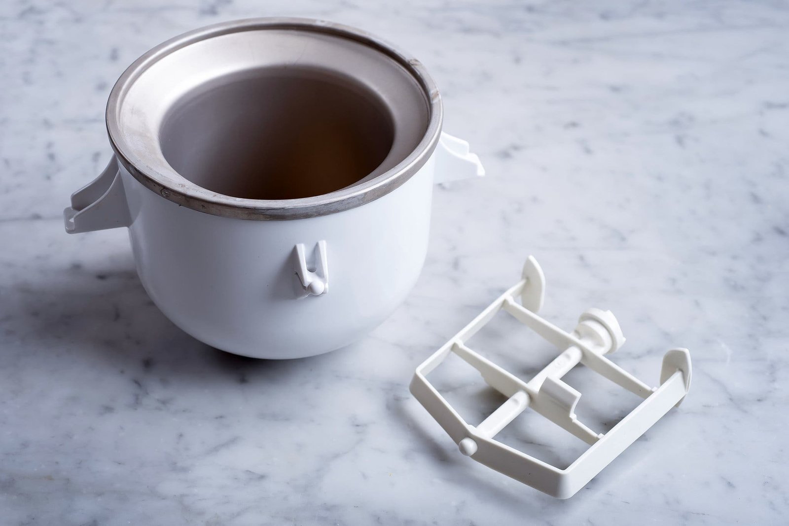 A side image of a freezer bowl ice cream maker and the churning attachment.