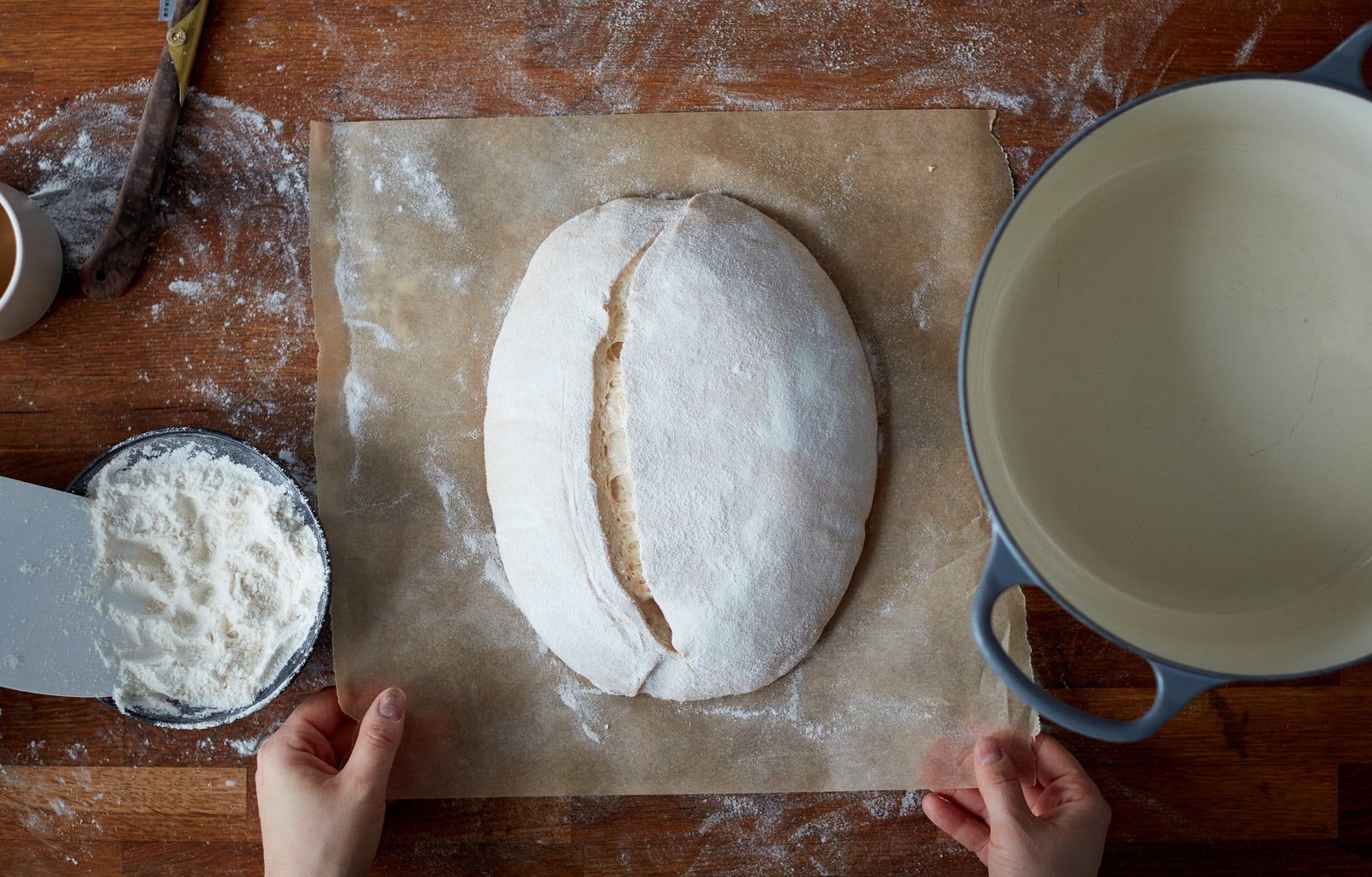 An overhead image of a loaf of sourdough cut along the side.