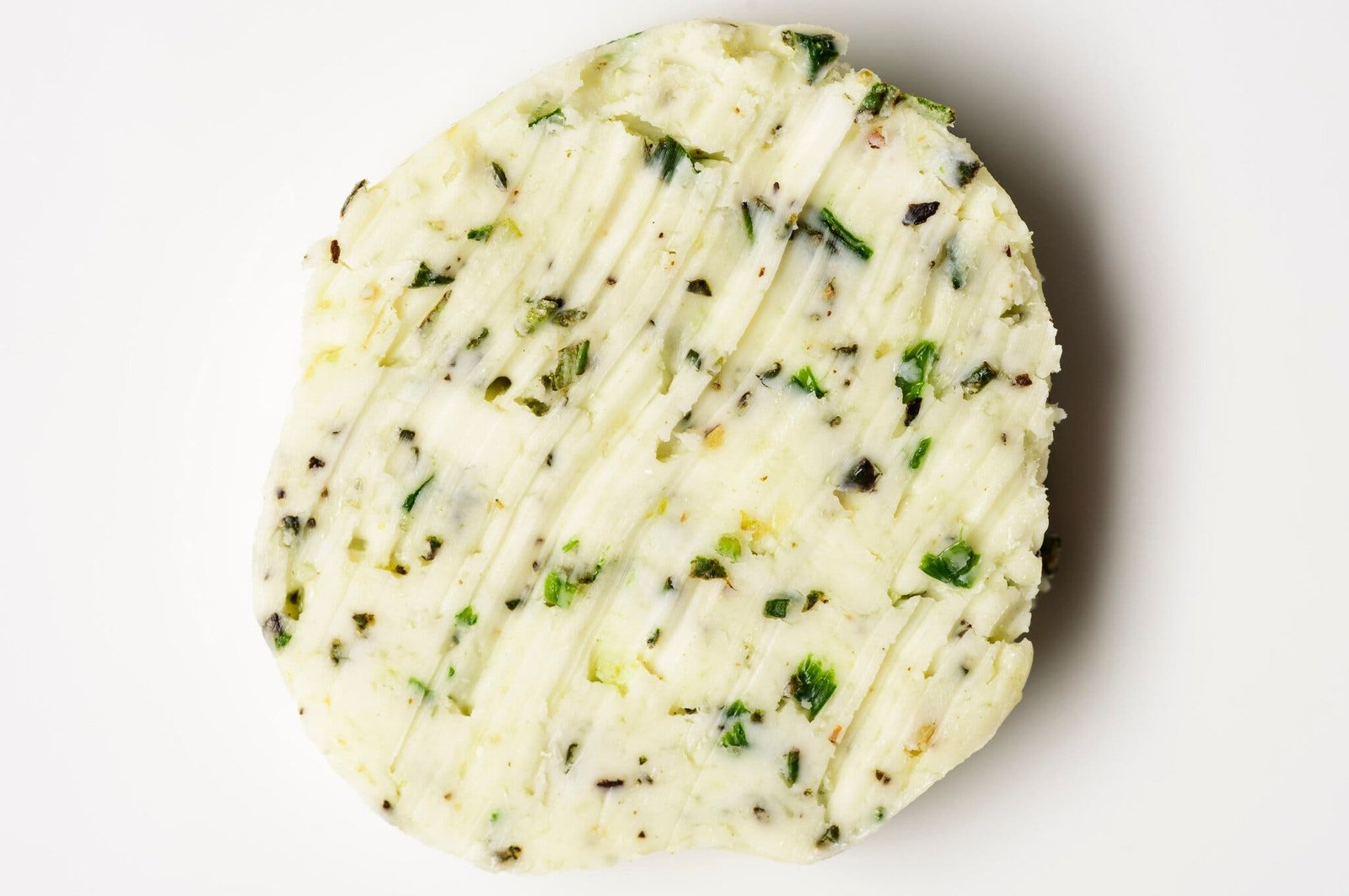An overhead image of herb-speckled butter.