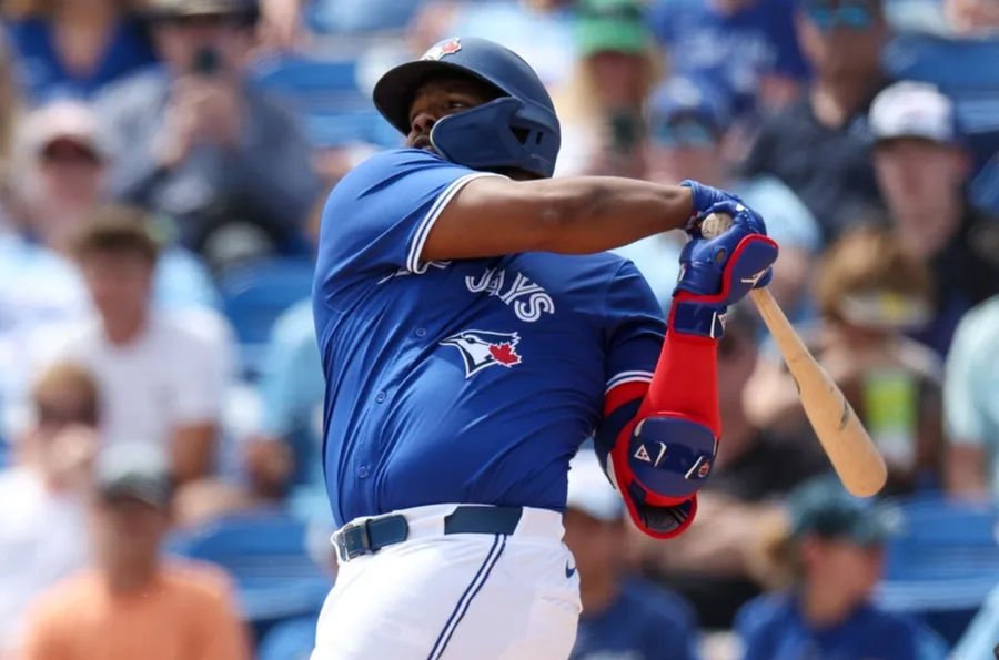 Mar 20, 2025; Dunedin, Florida, USA; Toronto Blue Jays first base Vladimir Guerrero Jr. (27) singles against the Tampa Bay Rays in the fifth inning during spring training at TD Ballpark. Mandatory Credit: Nathan Ray Seebeck-Imagn Images