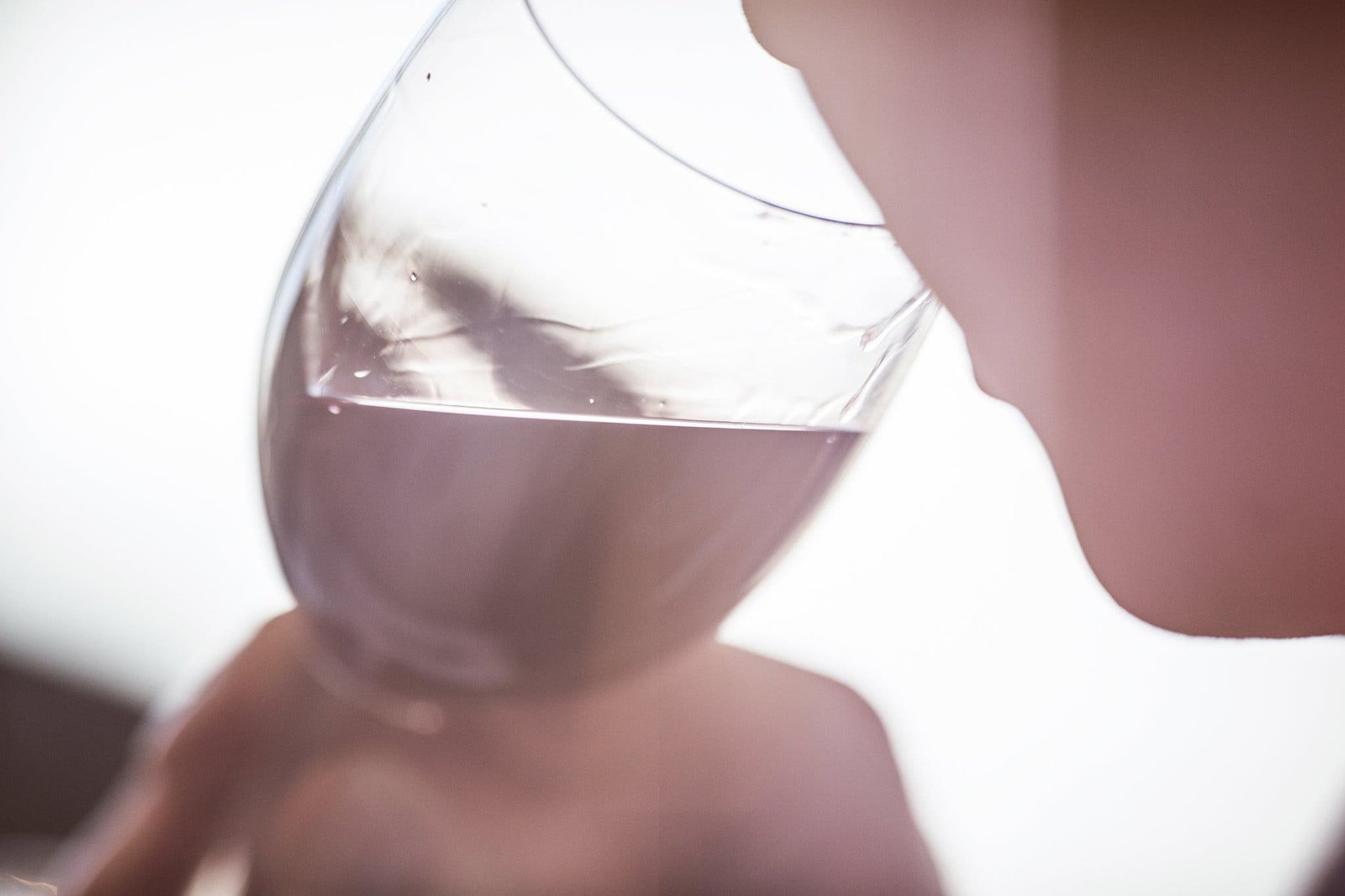 A person sniffs wine in a glass.