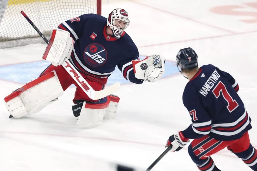 Winnipeg Jets center Vladislav Namestnikov (7) takes a shot on Winnipeg Jets goaltender Connor Hellebuyck (37) before a game against the New Jersey Devils at Canada Life Centre. Mandatory Credit: James Carey Lauder-Imagn Images