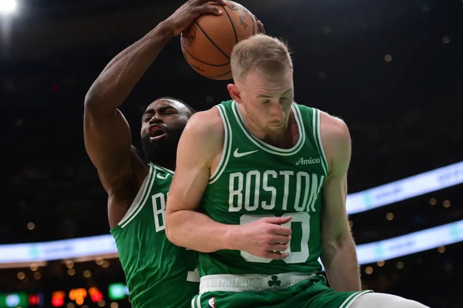 Mar 10, 2025; Boston, Massachusetts, USA; Boston Celtics guard Jaylen Brown (7) grabs a rebound in front of forward Sam Hauser (30) during the second half at TD Garden. Mandatory Credit: Bob DeChiara-Imagn Images