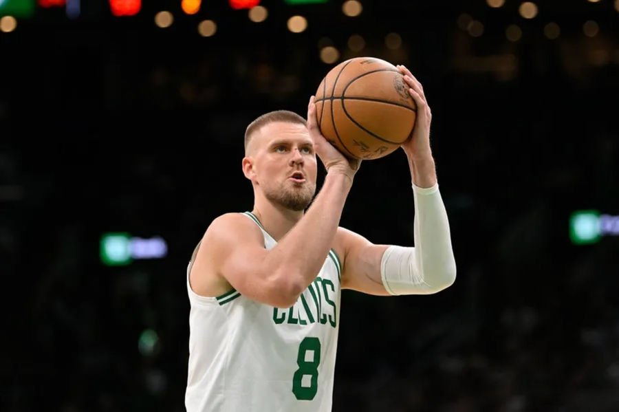 Apr 11, 2025; Boston, Massachusetts, USA; Boston Celtics center Kristaps Porzingis (8) shoots a free throw during the first half against the Charlotte Hornets at TD Garden. Mandatory Credit: Eric Canha-Imagn Images