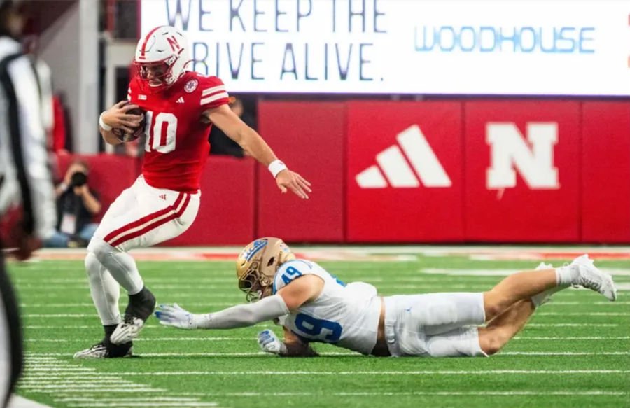 Nov 2, 2024; Lincoln, Nebraska, USA; Nebraska Cornhuskers quarterback Heinrich Haarberg (10) runs out of bounds against UCLA Bruins linebacker Carson Schwesinger (49) during the fourth quarter at Memorial Stadium. Mandatory Credit: Dylan Widger-Imagn Images