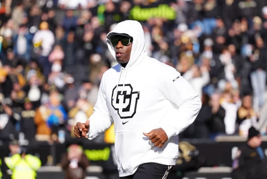 Nov 29, 2024; Boulder, Colorado, USA; Colorado Buffaloes head coach Deion Sanders runs onto the field before the game against the Oklahoma State Cowboys at Folsom Field. Mandatory Credit: Ron Chenoy-Imagn Images