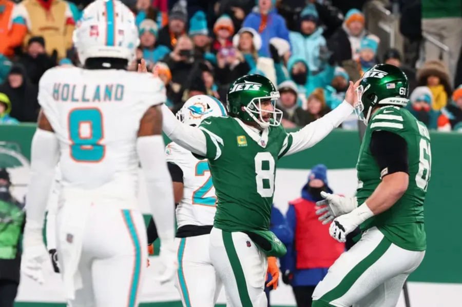 Jan 5, 2025; East Rutherford, New Jersey, USA; New York Jets quarterback Aaron Rodgers (8) celebrates after throwing his 500th touchdown pass during the second quarter of their game against the Miami Dolphins at MetLife Stadium. Mandatory Credit: Ed Mulholland-Imagn Images