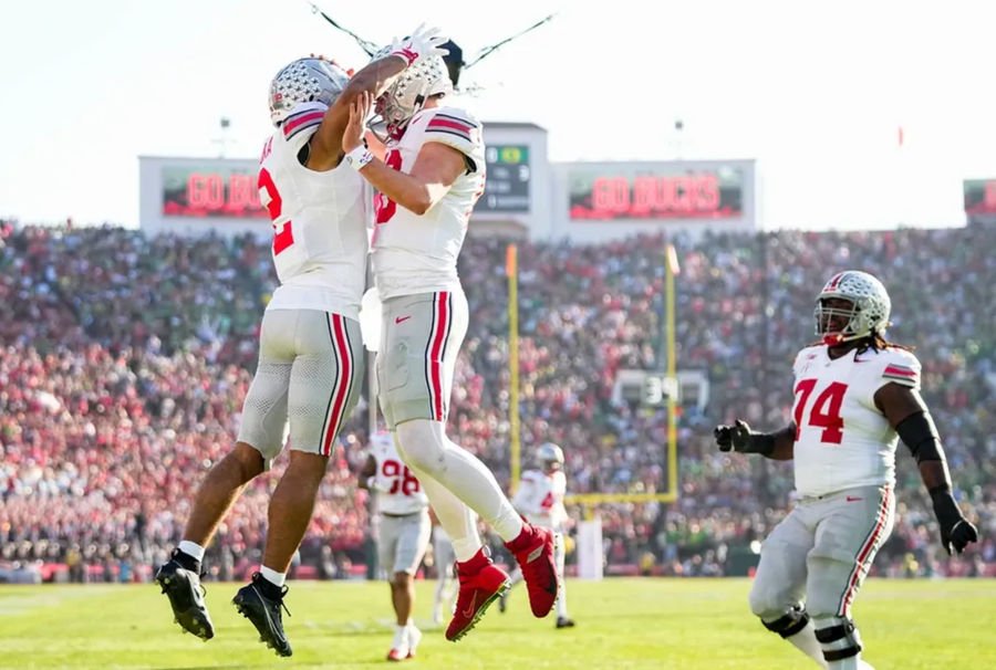 Ohio State Buckeyes wide receiver Emeka Egbuka (2) celebrates a touchdown catch with quarterback Will Howard (18) during the first half of the College Football Playoff quarterfinal against the Oregon Ducks at the Rose Bowl in Pasadena, Calif. on Jan. 1, 2025.