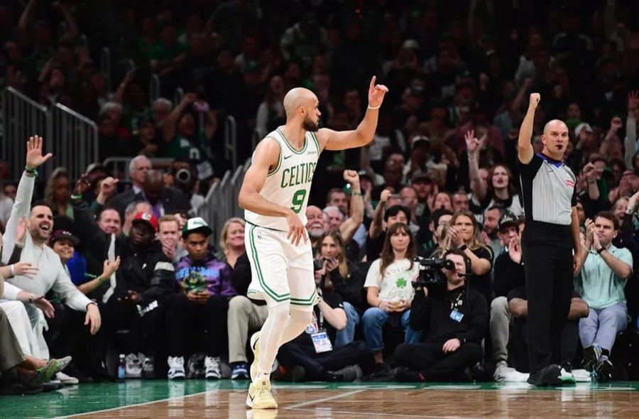 Apr 20, 2025; Boston, Massachusetts, USA; Boston Celtics guard Derrick White (9) reacts after making a three point basket during the first half against the Orlando Magic at TD Garden. Mandatory Credit: Bob DeChiara-Imagn Images