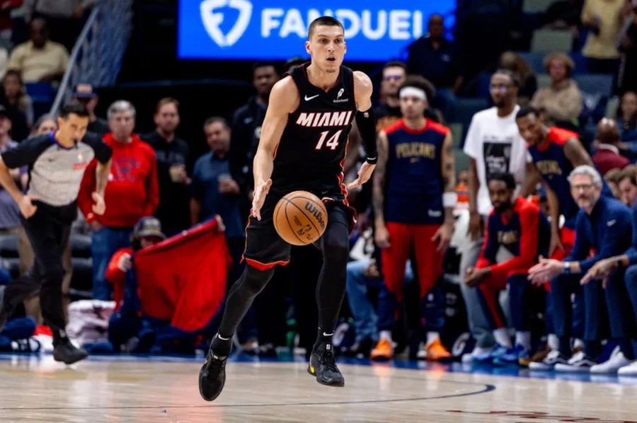 Apr 11, 2025; New Orleans, Louisiana, USA; Miami Heat guard Tyler Herro (14) brings the ball up court against the New Orleans Pelicans during the first half at Smoothie King Center. Mandatory Credit: Stephen Lew-Imagn Images