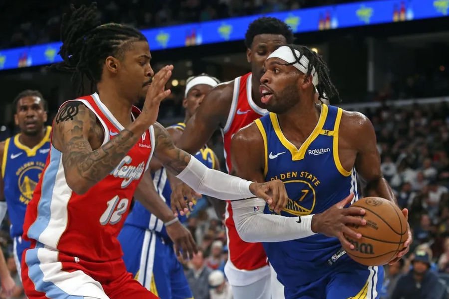 Apr 1, 2025; Memphis, Tennessee, USA; Golden State Warriors guard Buddy Hield (7) drives to the basket as Memphis Grizzlies guard Ja Morant (12) defends during the third quarter at FedExForum. Mandatory Credit: Petre Thomas-Imagn Images
