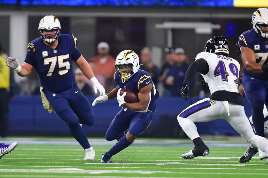 Nov 25, 2024; Inglewood, California, USA; Los Angeles Chargers running back J.K. Dobbins (27) runs the ball against the Baltimore Ravens during the first half at SoFi Stadium. Mandatory Credit: Gary A. Vasquez-Imagn Images