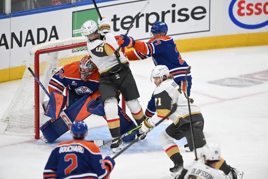 May 10, 2025; Edmonton, Alberta, CAN; Edmonton Oilers goalie Stuart Skinner (74) looks for the puck while Vegas Golden Knights right winger Keegan Kolesar (55) and Oilers defenceman Brett Kulak (27) battle during the third period in game three of the second round of the 2025 Stanley Cup Playoffs at Rogers Place. Mandatory Credit: Walter Tychnowicz-Imagn Images