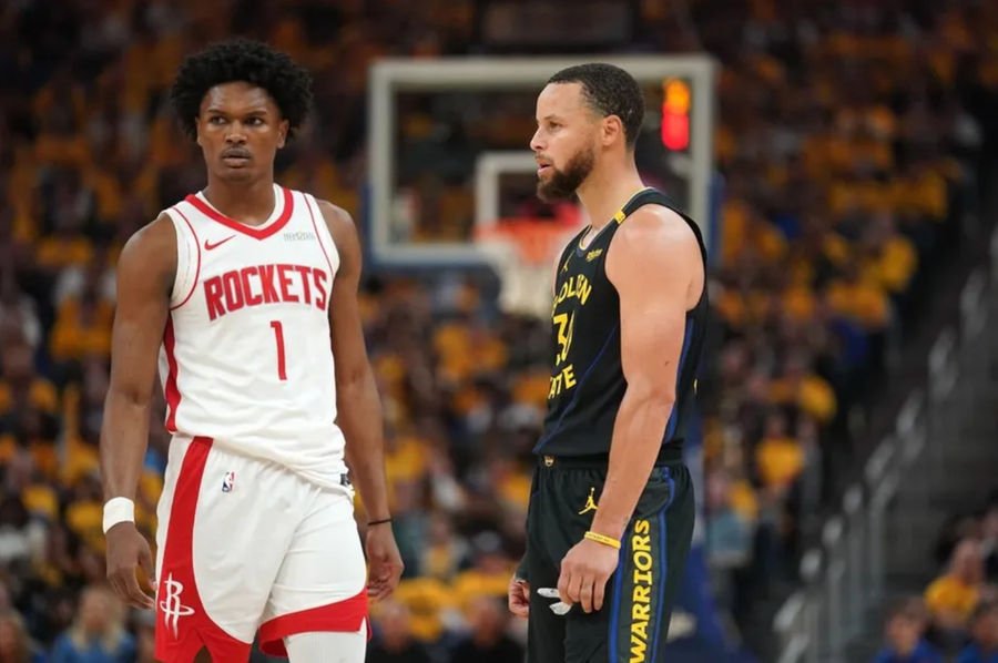 May 2, 2025; San Francisco, California, USA; Houston Rockets forward Amen Thompson (1) stands next to Golden State Warriors guard Stephen Curry (30) during a break in the action in the second quarter of game six of the first round for the 2025 NBA Playoffs at Chase Center. Mandatory Credit: Cary Edmondson-Imagn Images